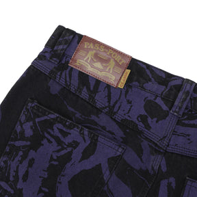 Close-up of dark blue camouflage pants with a visible brand label on a white background