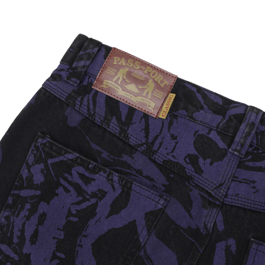 Close-up of dark blue camouflage pants with a visible brand label on a white background