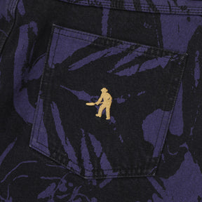 Close-up of a pocket with a gold embroidered design on a dark fabric background