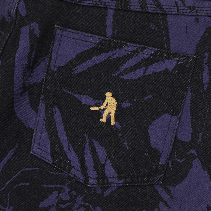 Close-up of a pocket with a gold embroidered design on a dark fabric background