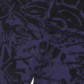 Close-up of a patterned fabric with black and white design on a dark background