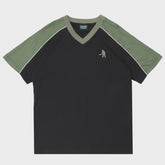 Black t-shirt with green sleeves and collar on a white background