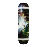 A skateboard deck featuring a photographic art print of a waterfall and forest, shown vertically against a plain white background.