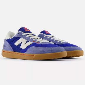 Blue and gray sneakers with white laces on a white background