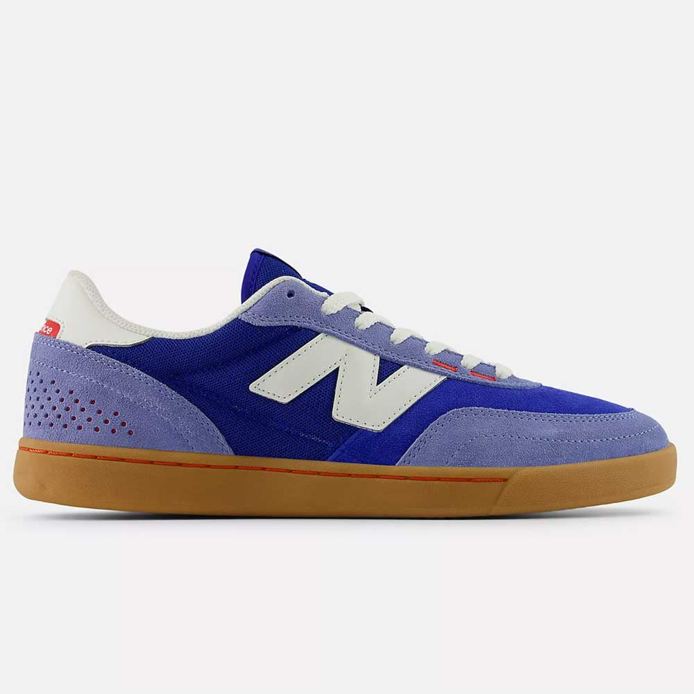 Blue sneaker with white accents on a light gray background