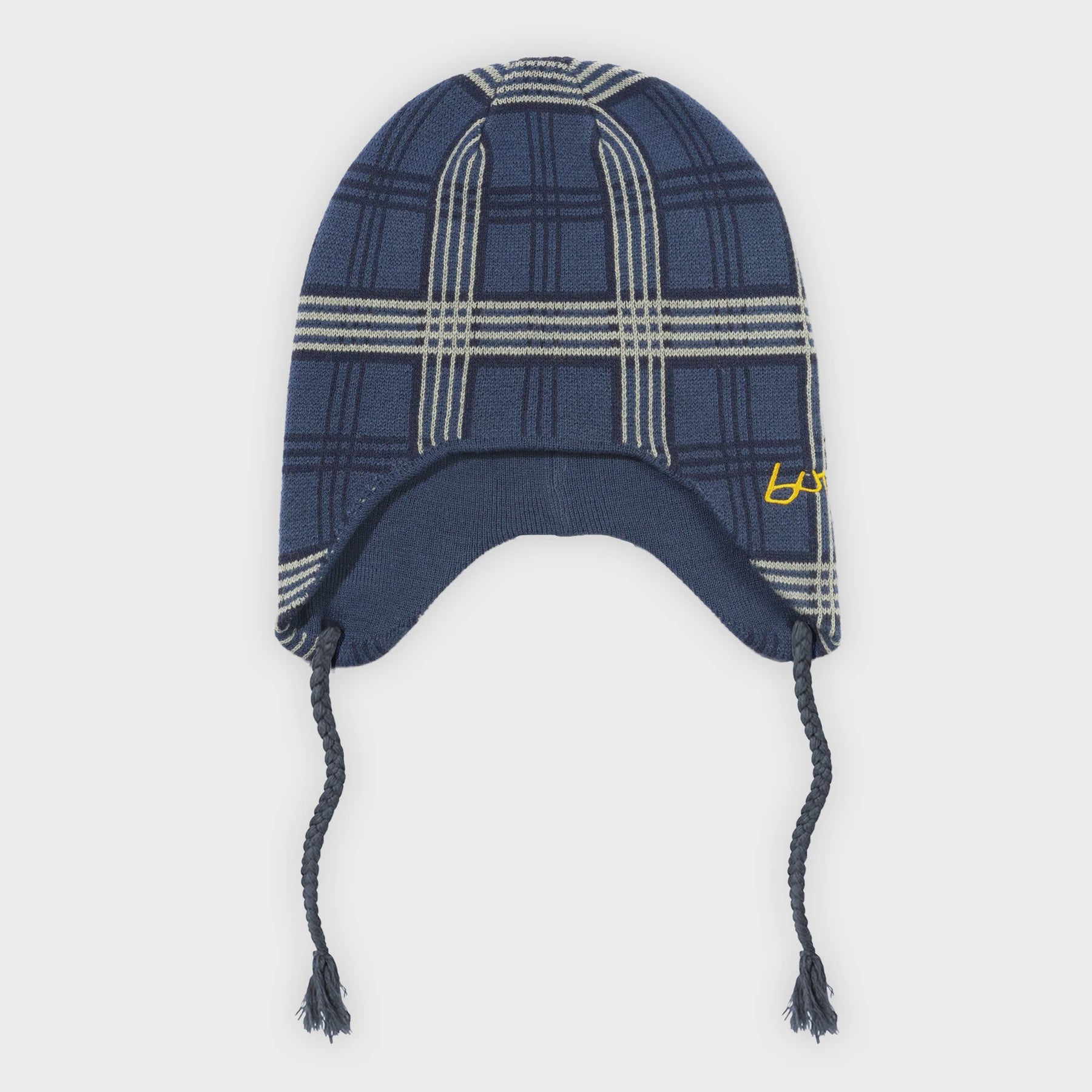 Plaid patterned beanie with earflaps on a white background