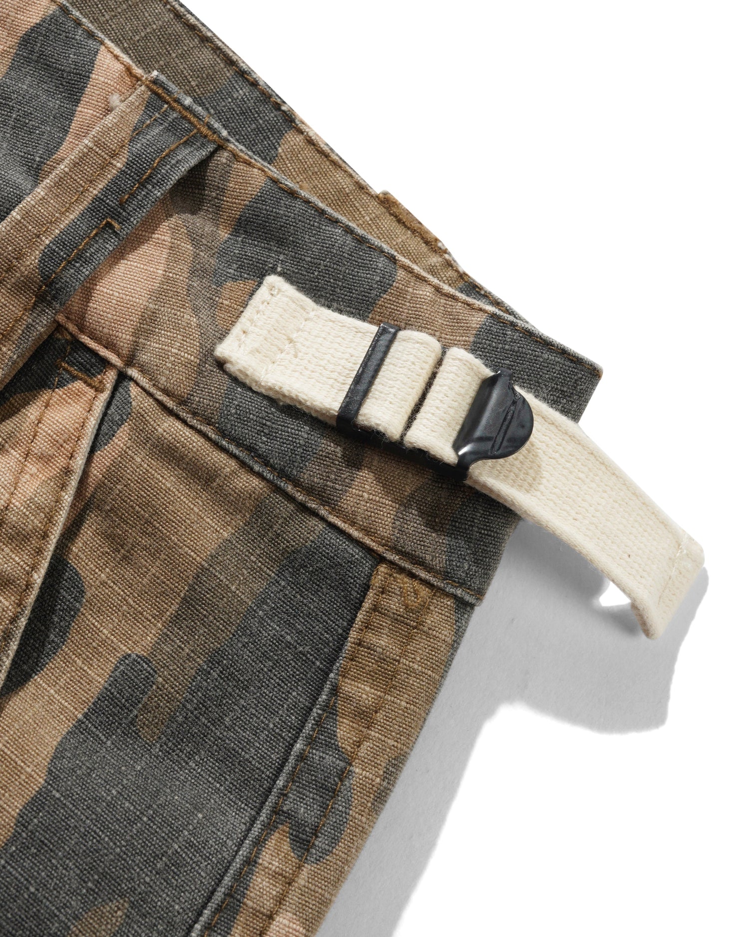 Camouflage pants with a belt and buckle on a white background