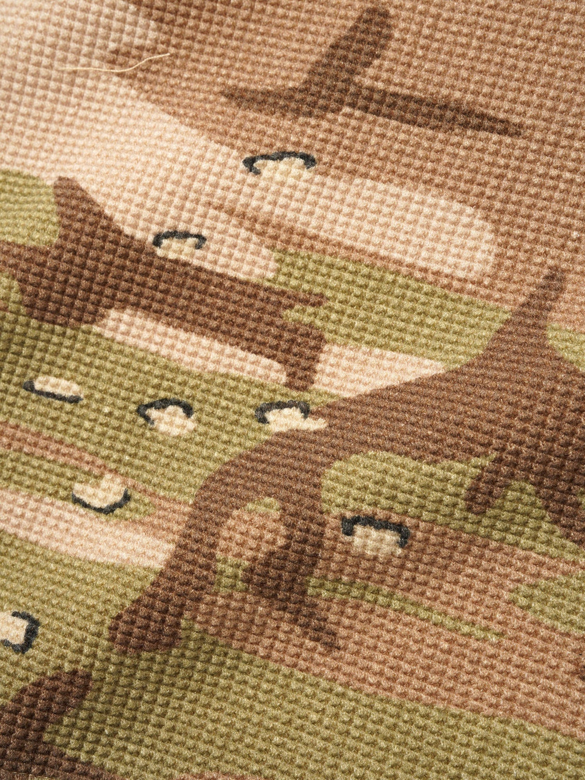 Close-up of a cross-stitched design featuring horses on fabric.