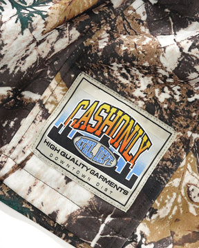 Close-up of a camouflage-patterned fabric with a 'Cashonly' label.