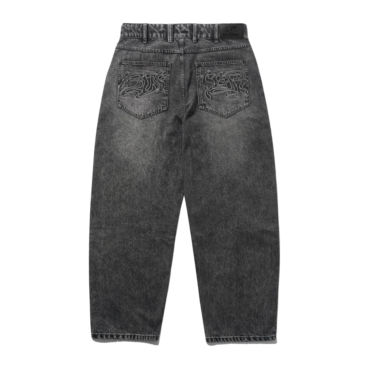 Back view of dark gray acid-wash jeans with embroidered lion designs on the back pockets, shown on a plain white background.