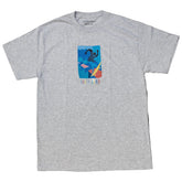 A heather gray short-sleeve t-shirt with a colorful graphic print on the chest depicting a stylized figure in blue, yellow, and red, with the text 'SIC I TUI WIN' below it.
