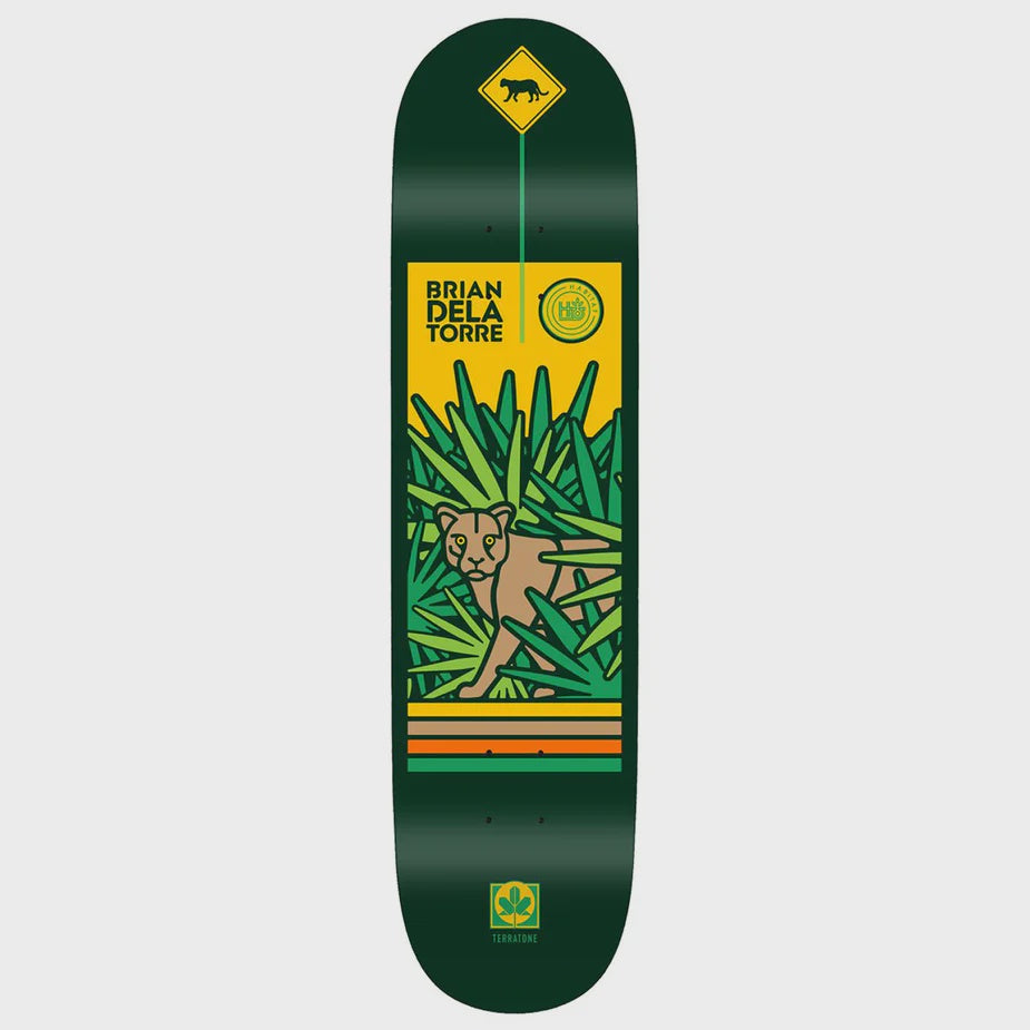 Skateboard deck with a design of a panther in the jungle and branding on a green background