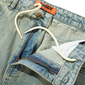 Close-up of a blue denim jacket with a brand tag on a white background
