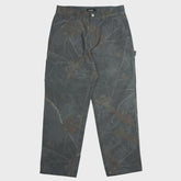 Dark gray pants with leaf pattern on a light gray background