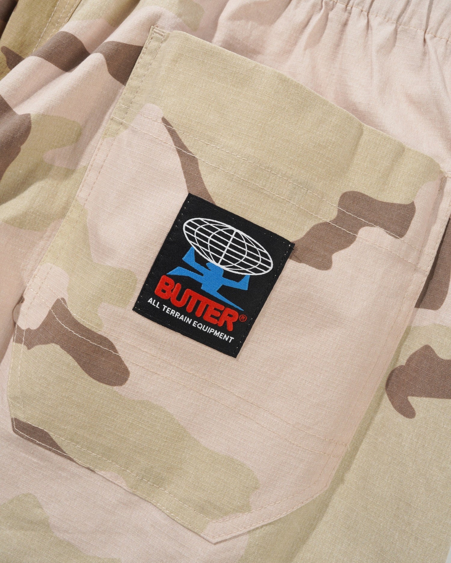 Camouflage pants with a visible brand logo on a pocket