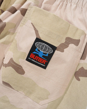 Camouflage pants with a visible brand logo on a pocket