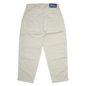 Beige pants with a brand label on a white background