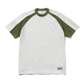 A short-sleeve raglan t-shirt with a light heather gray body and olive green raglan sleeves, collar, and cuffs. A small gray brand label is visible near the bottom hem.