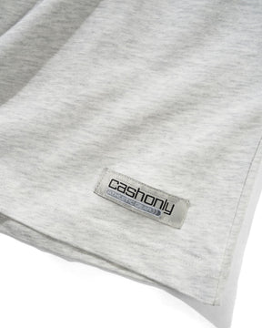 Close-up of a light heather gray fabric garment with a visible Cashony label sewn near the hem.