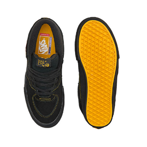Black sneakers with yellow soles on a white background