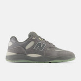 Gray sneaker with New Balance logo on a white background