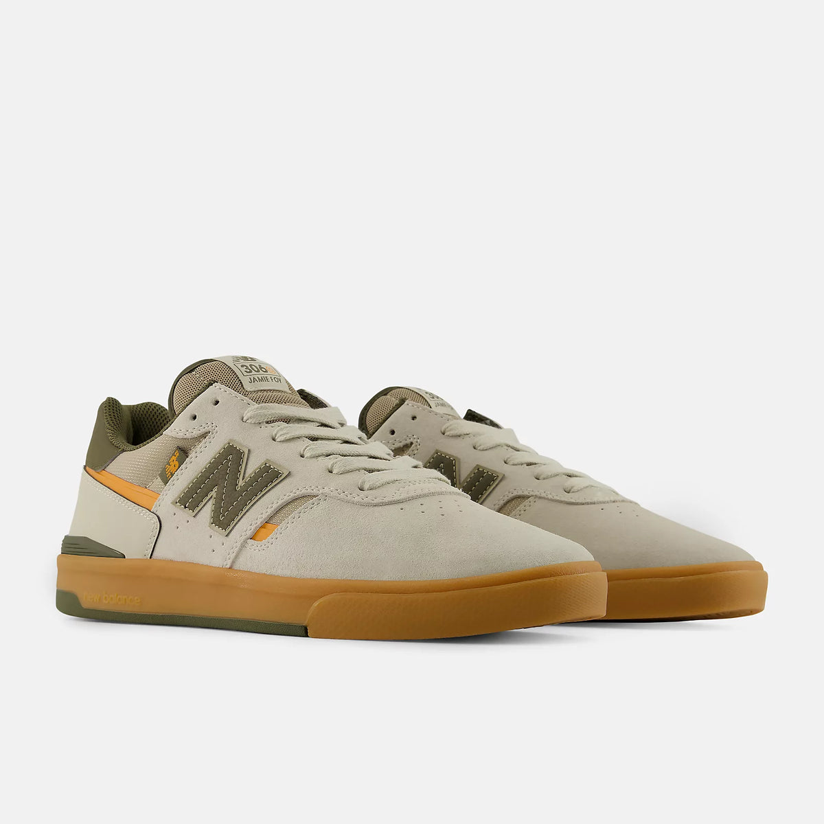 Pair of beige sneakers with brown soles on a white background