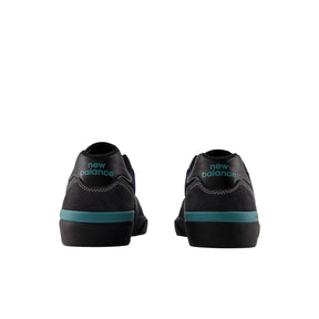 Black high-top sneakers with teal accents on a white background