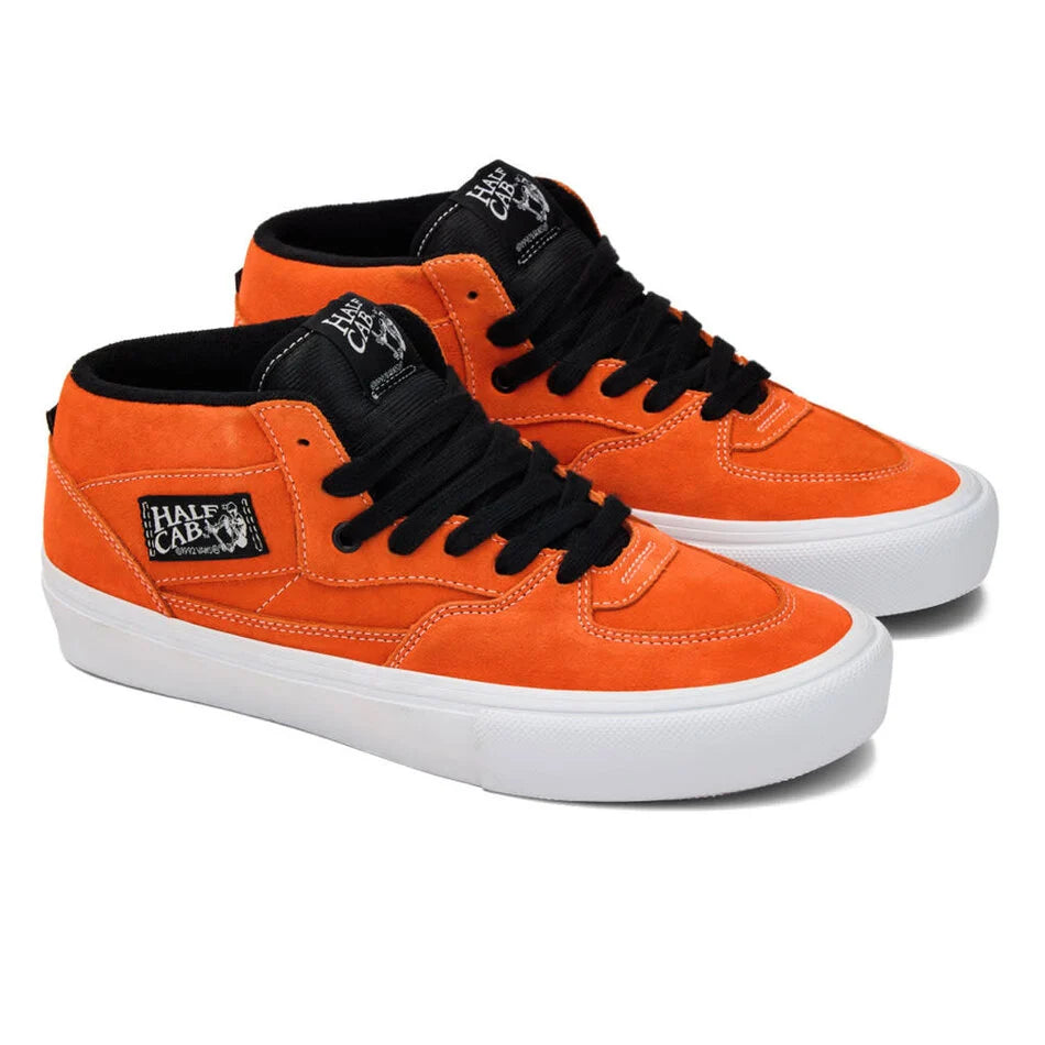 Orange high-top sneakers with black laces on a white background