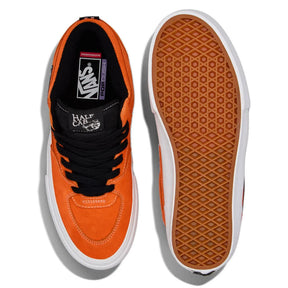 Orange Vans sneaker with black laces and white sole on a white background